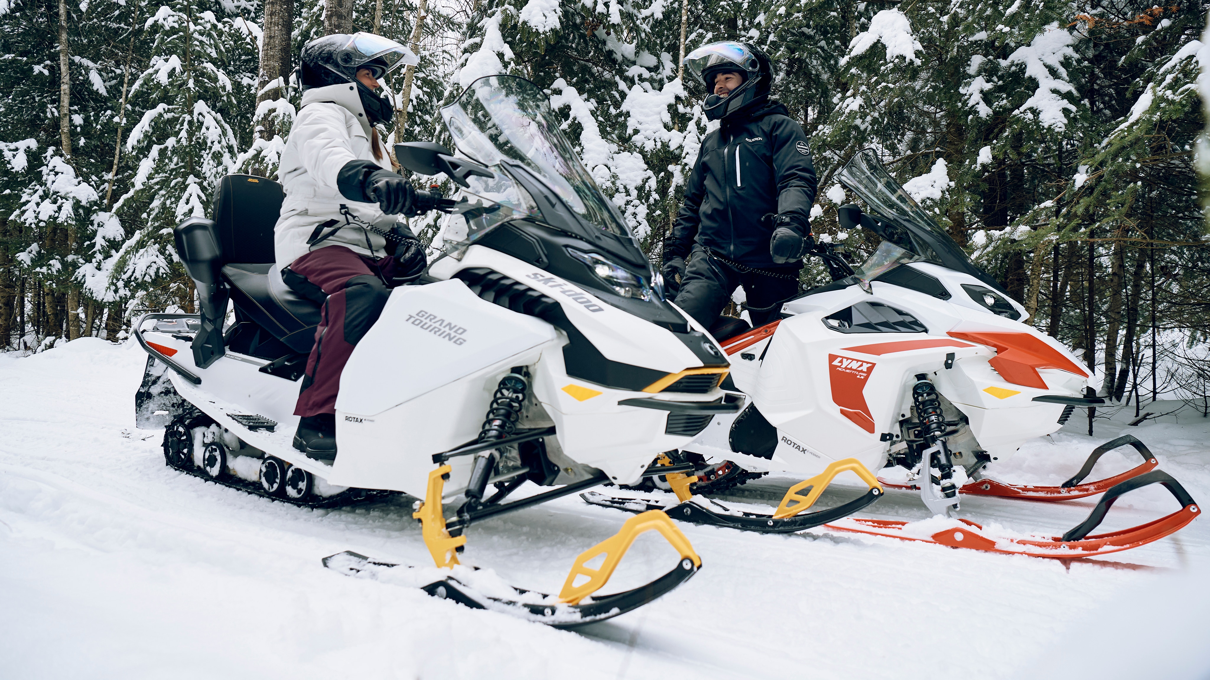 couple having fun on electric snowmobile