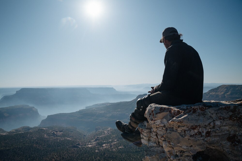 man looking out over a cliff