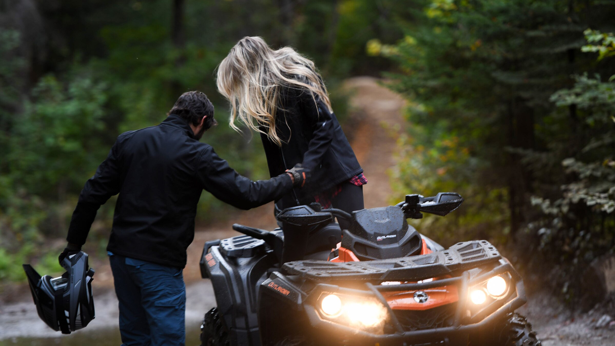 couple dismounting a Can-Am ATV