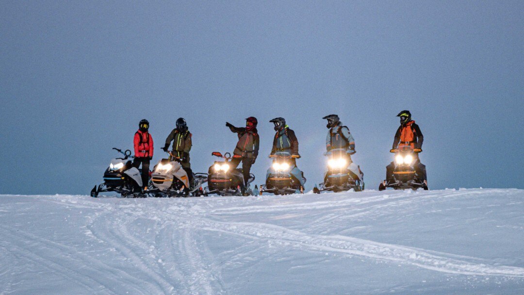 group of riders on a mountain ridge