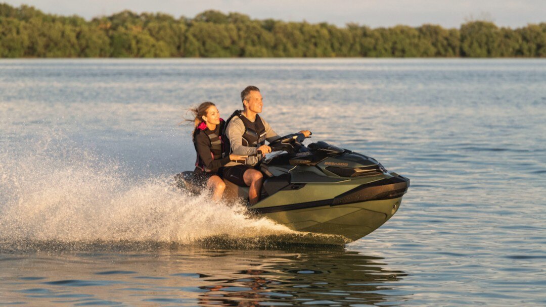 A couple riding a pwc on water