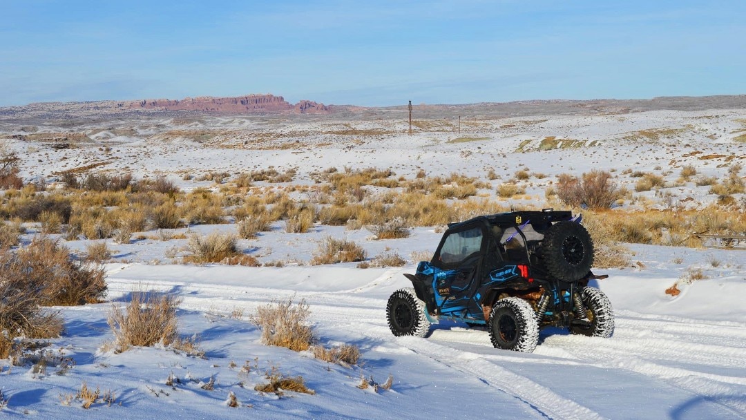 A Can-Am off-road parked with a canyon view