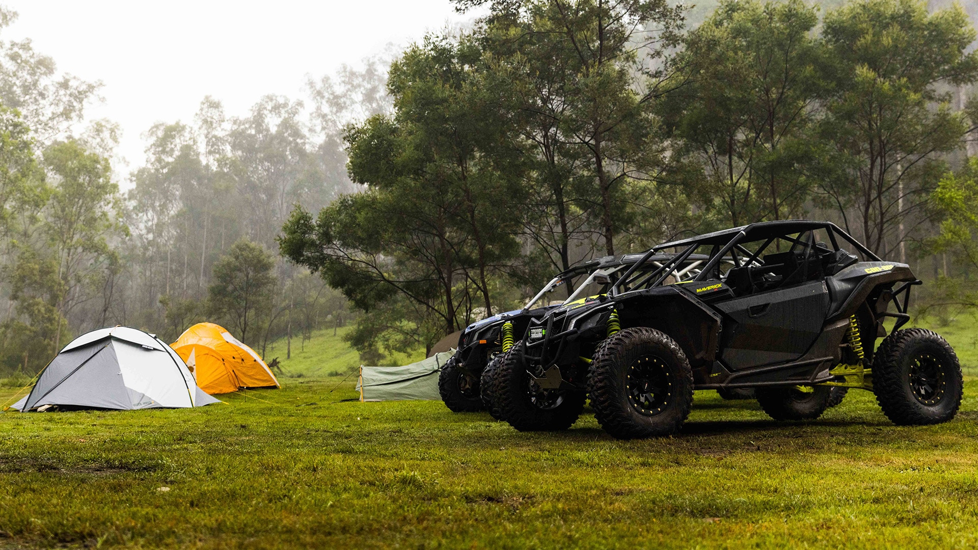 Can-Am Off-Road vehicles near camp tents
