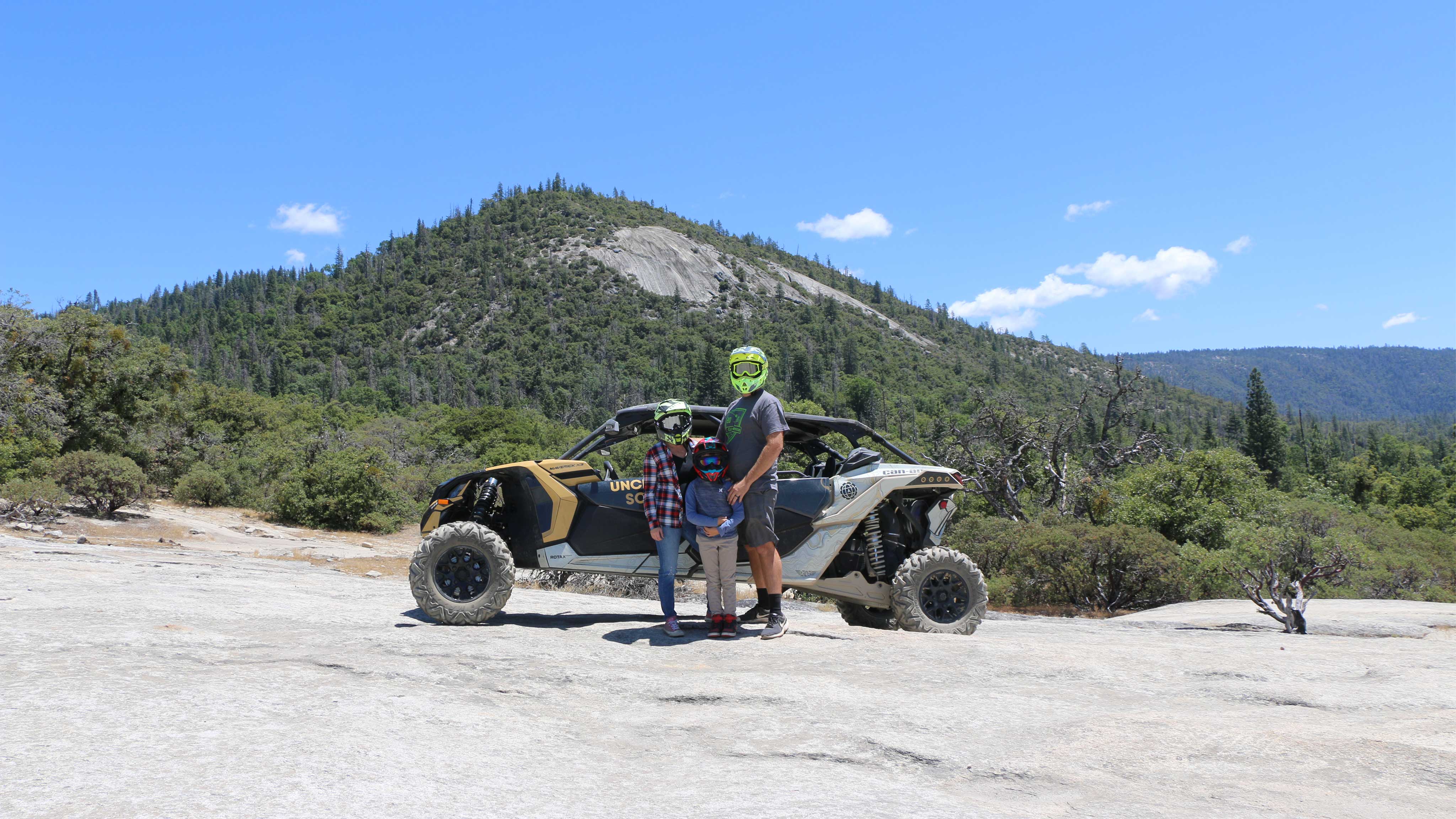 A rider riding a SxS vehicle near rocks