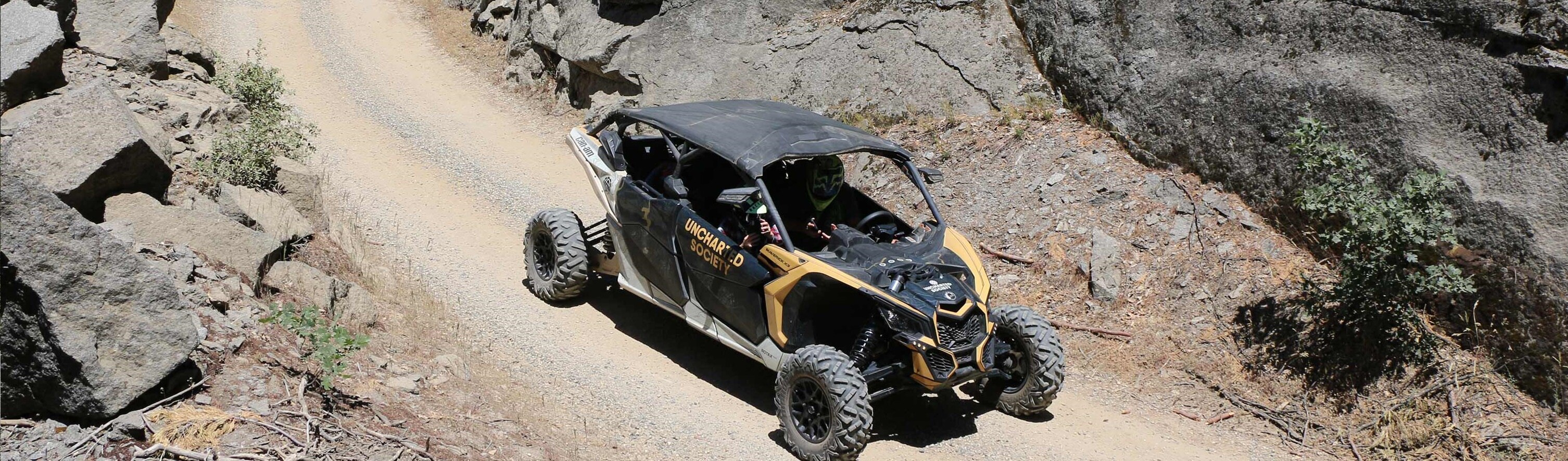 A family standing in front of a SxS ride