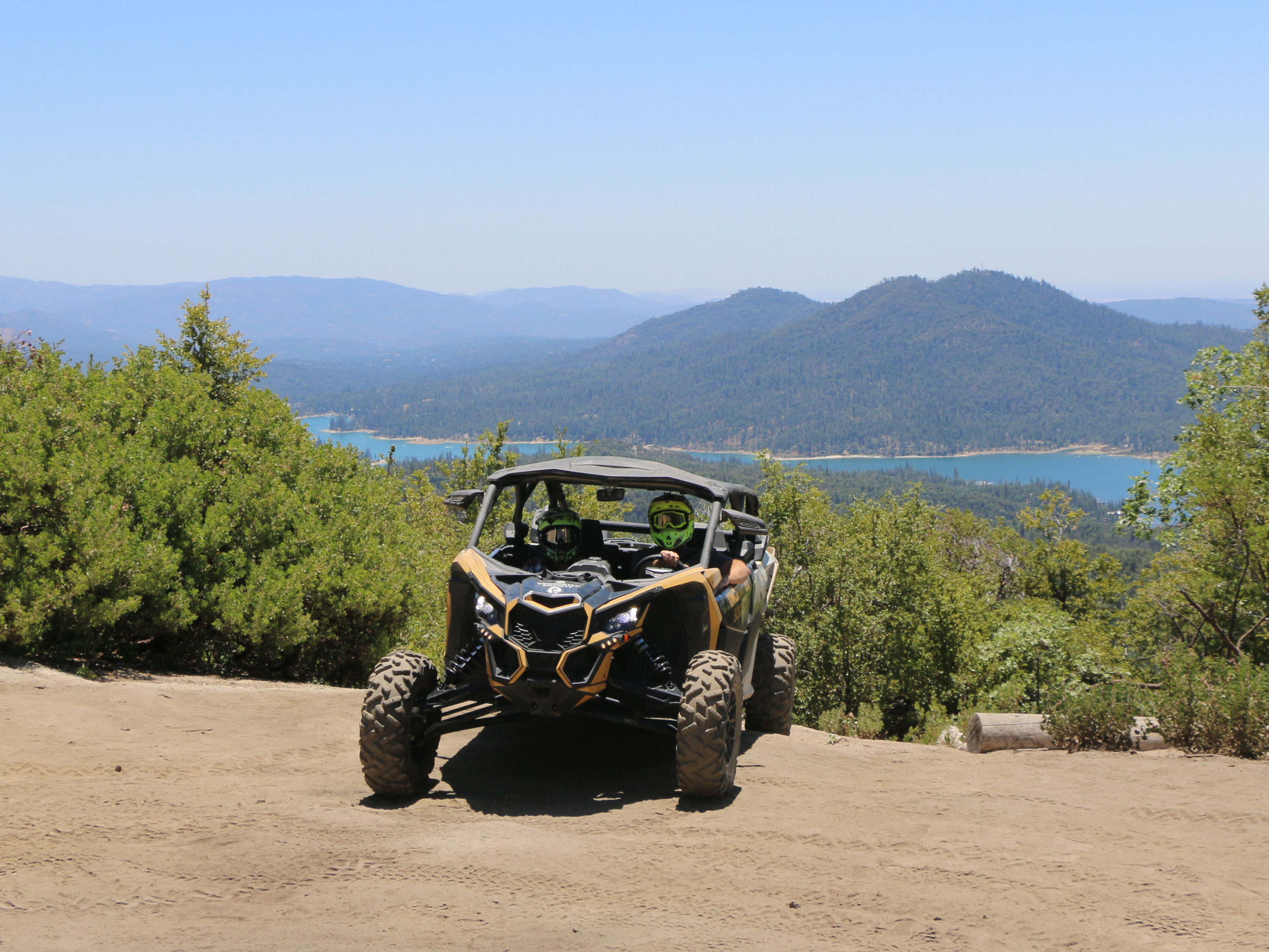 A Can-Am SxS in front of a mountain view