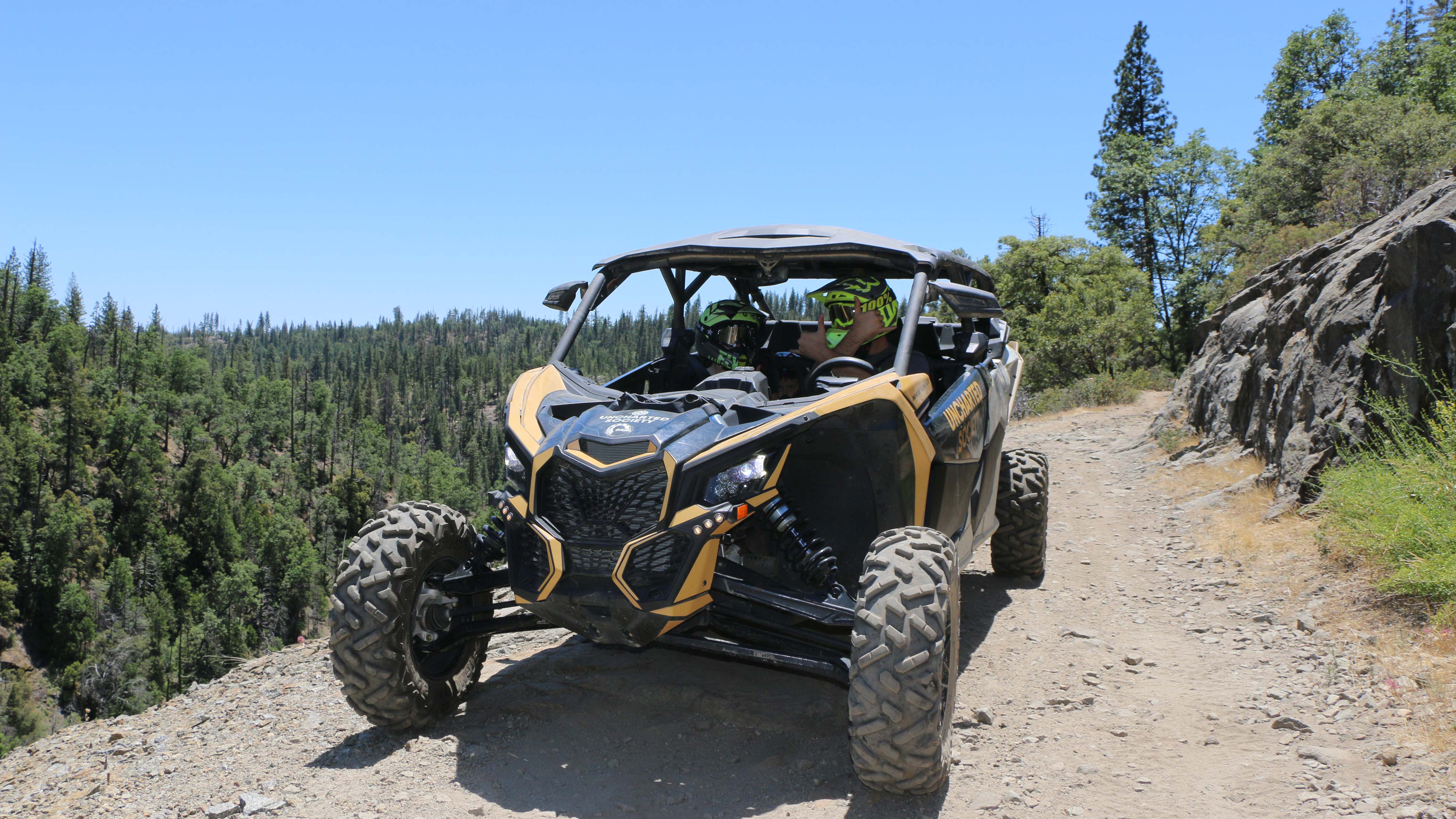 A father and son in a Can-Am SxS vehicle