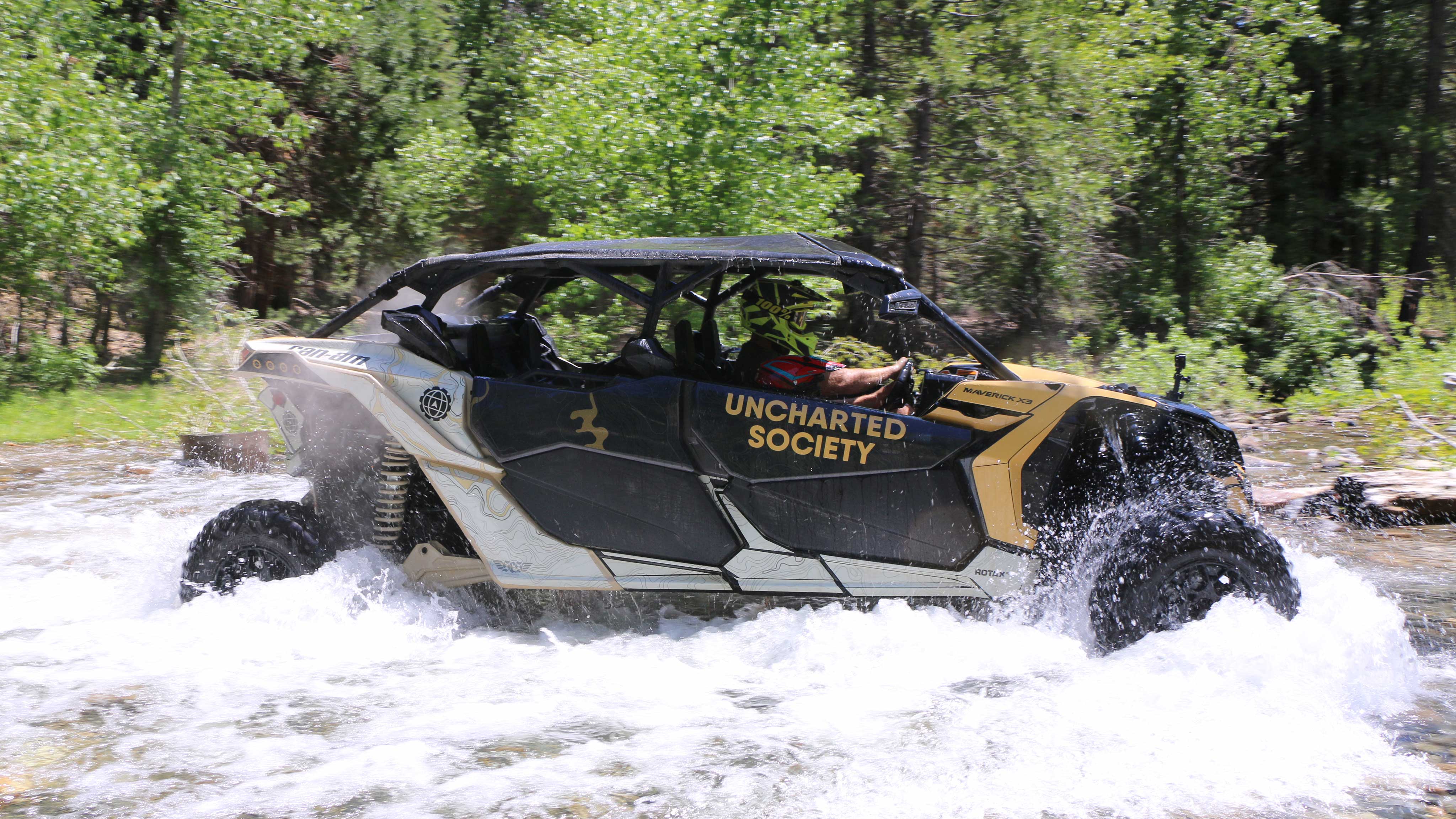 A rider riding a SxS vehicle near rocks