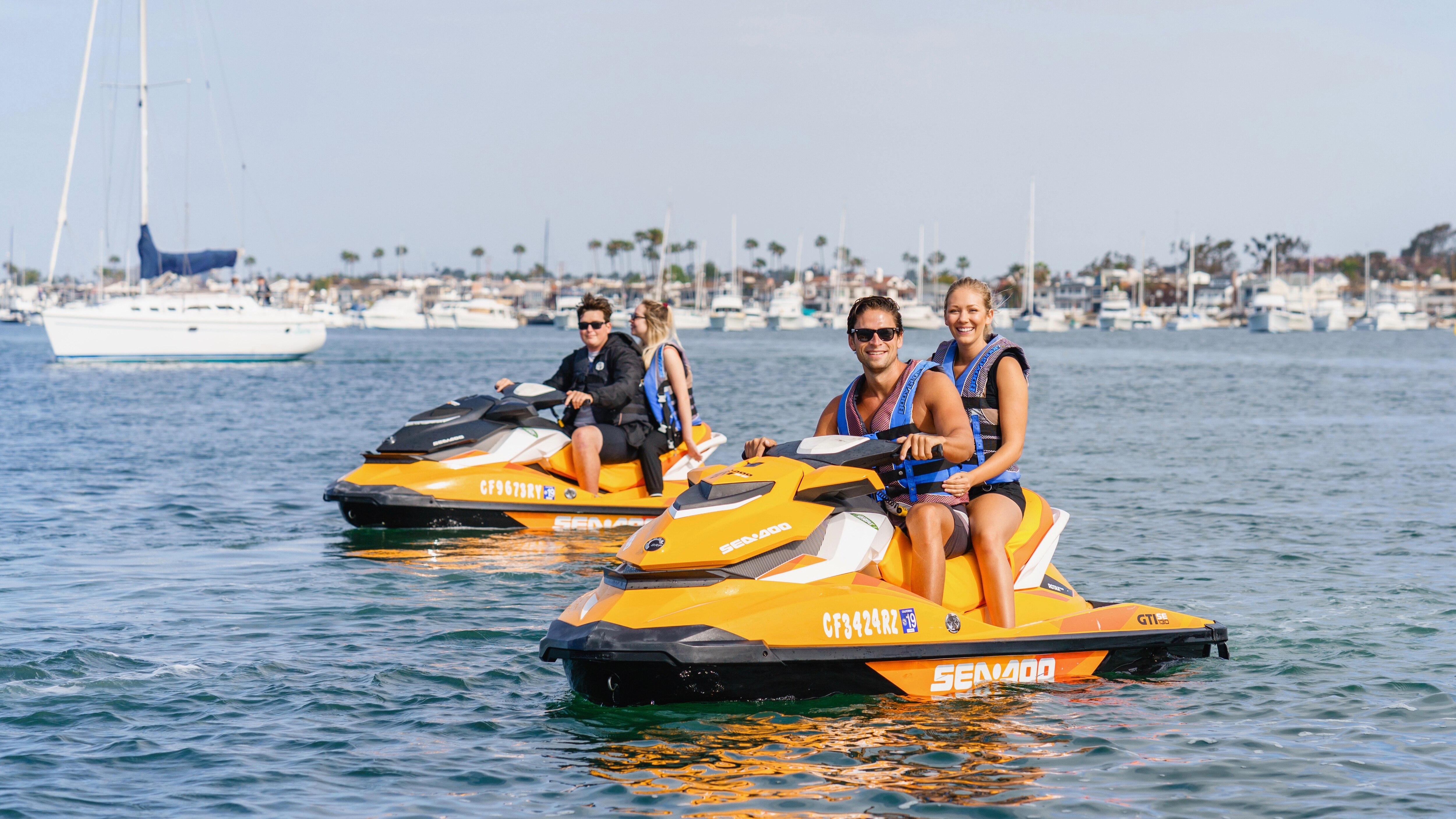 A group of friends on Sea-Doo in harbour 