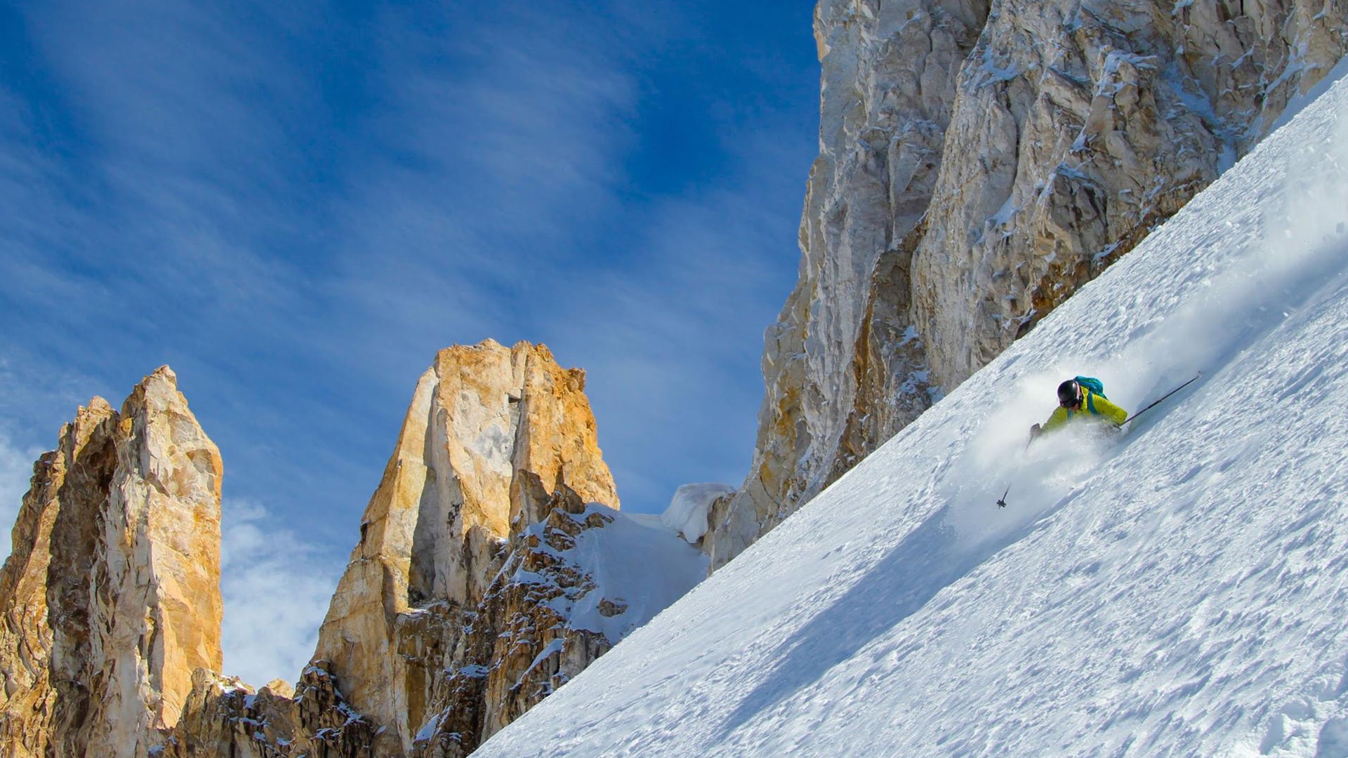 A person downhill skiing on a mountain
