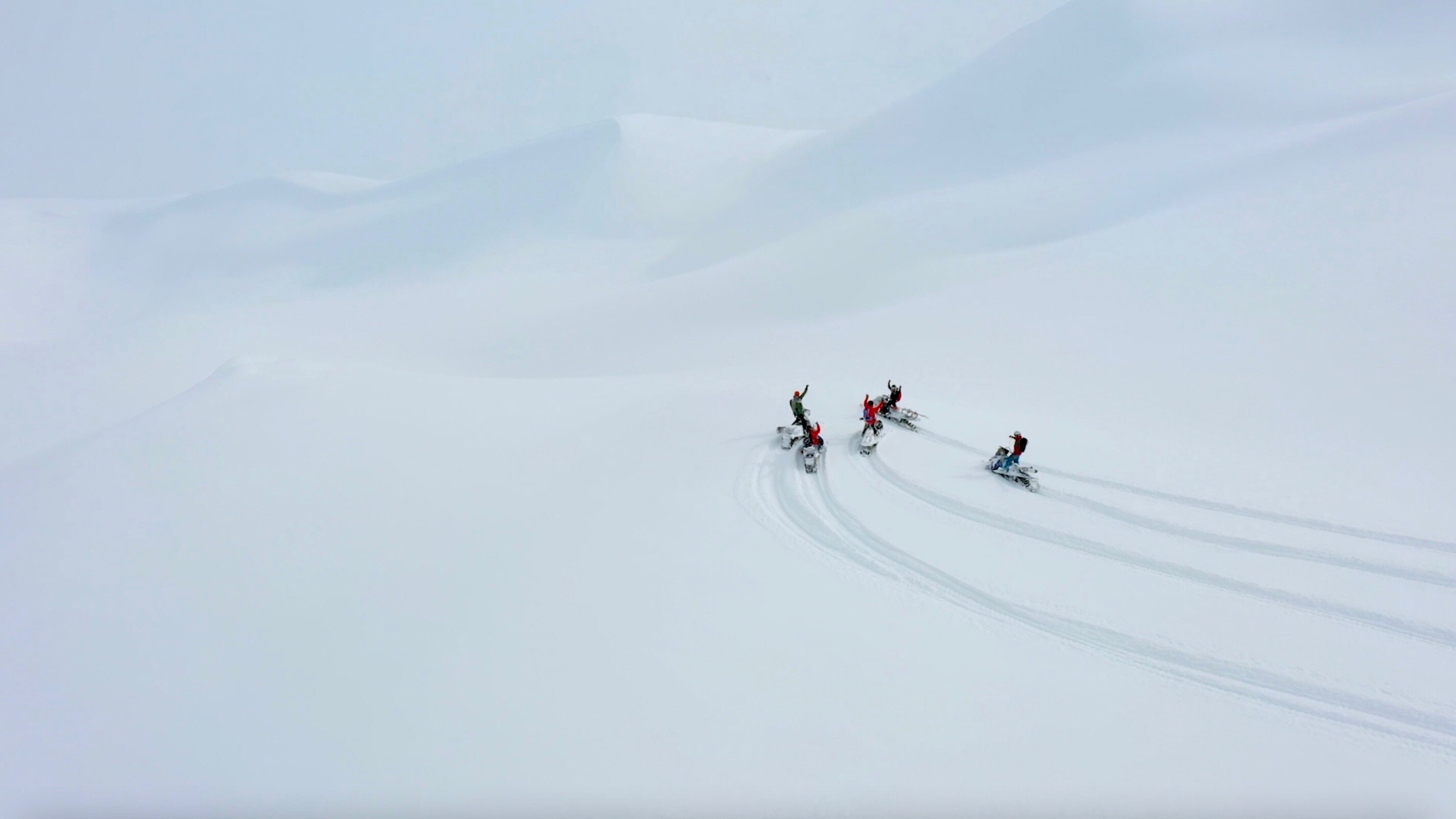 Snowmobilers cheering up in deep snow