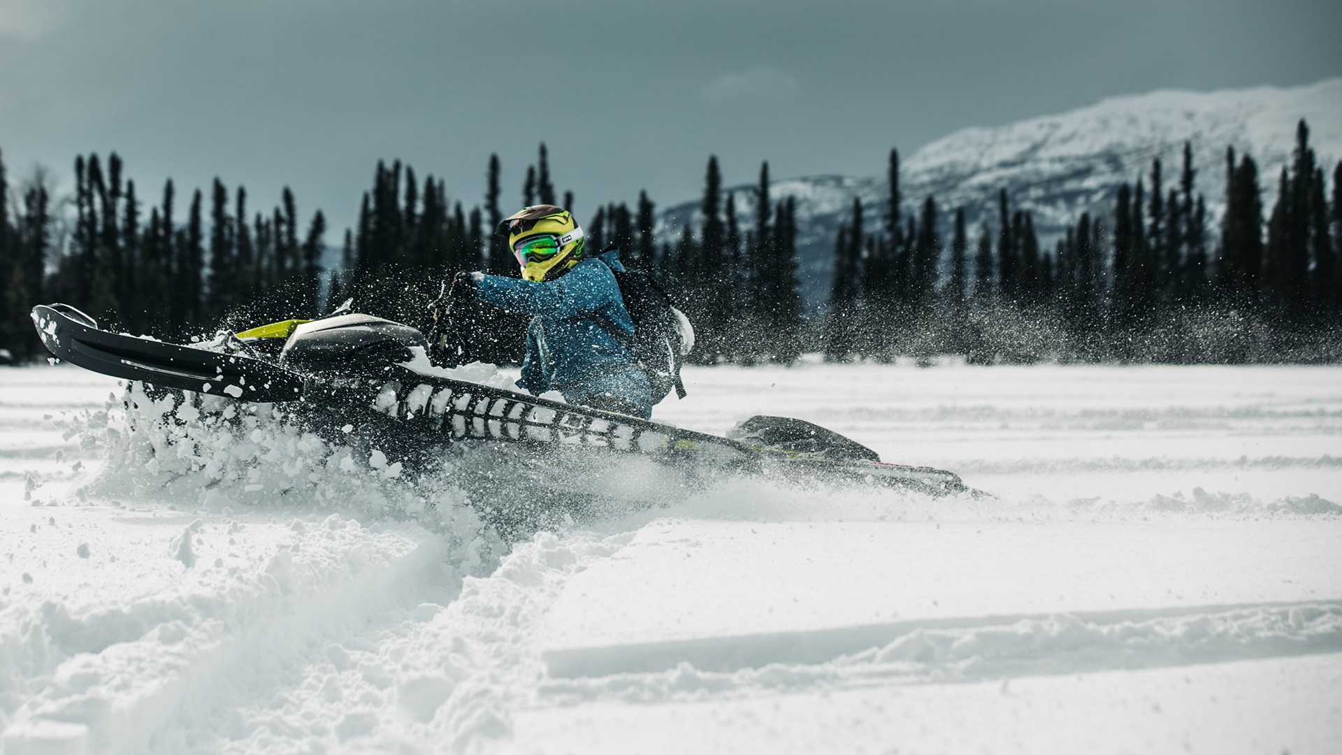 A Ski-Doo rider kicking up snow