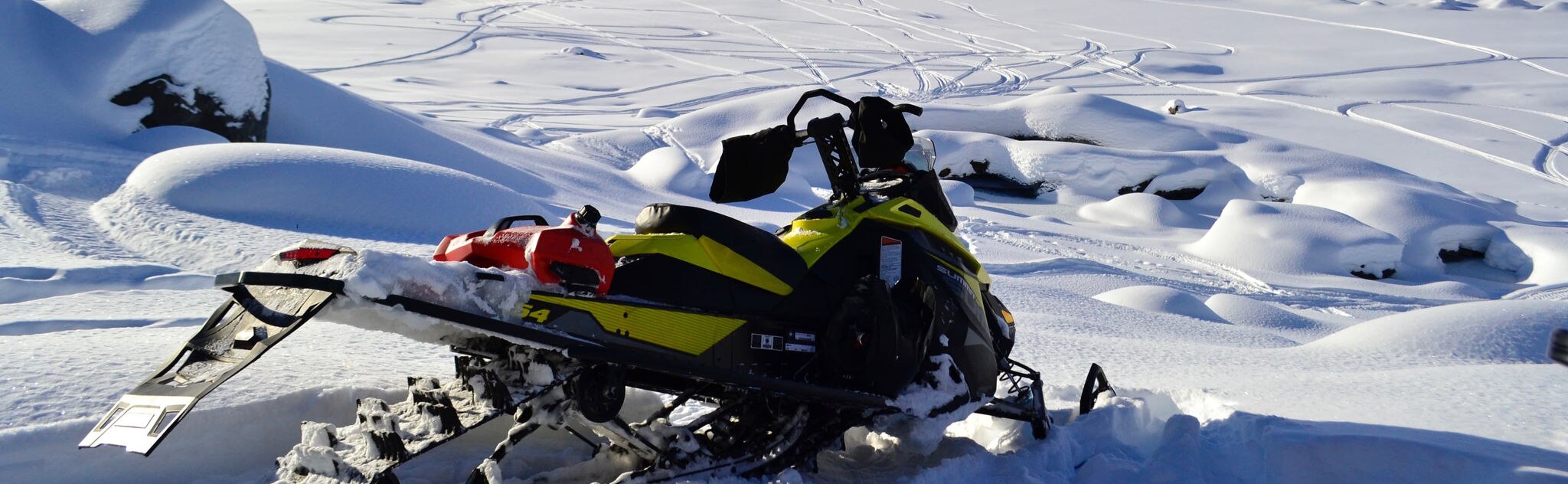 A Ski-Doo in front of big mountains 