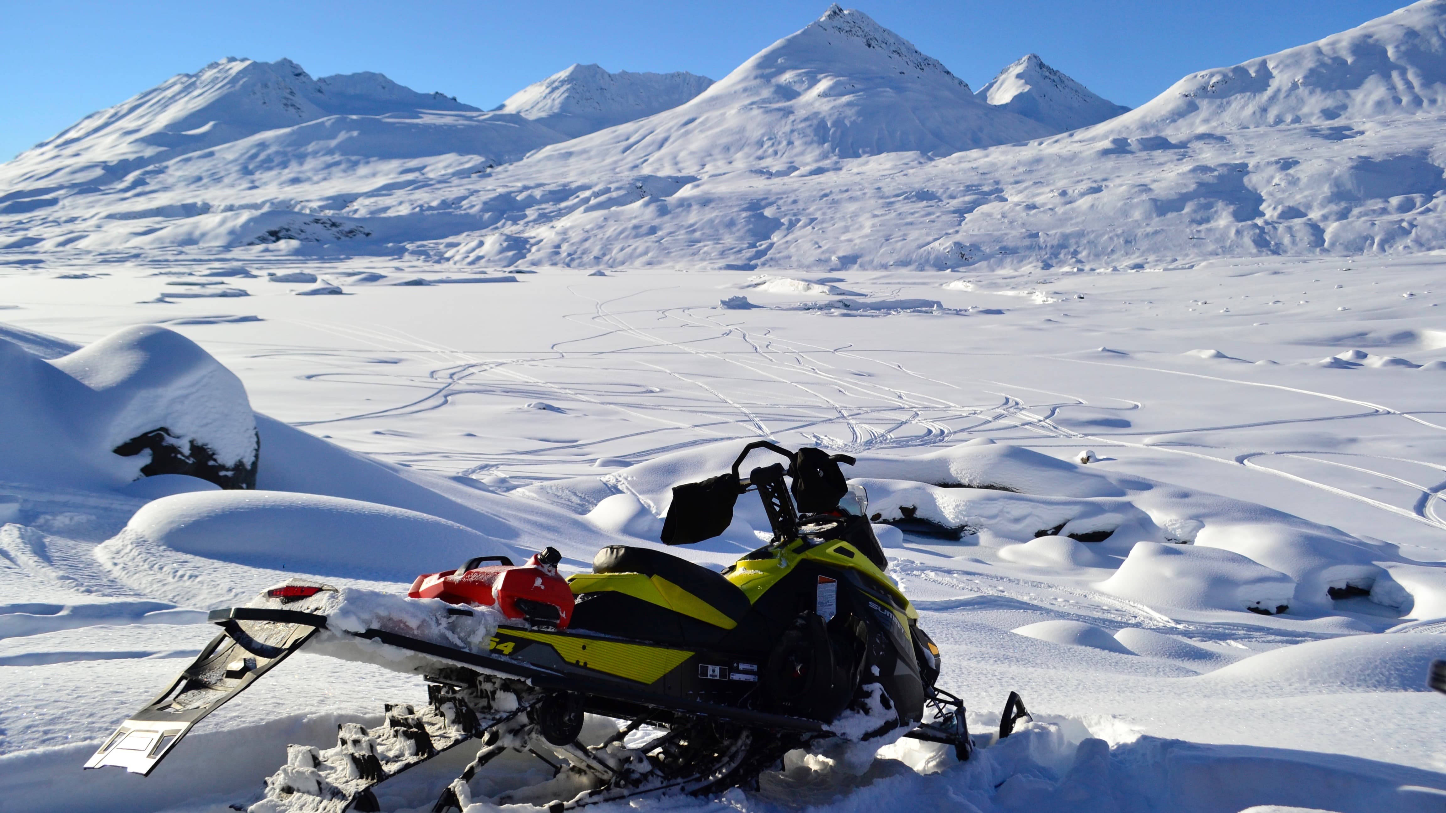 A Ski-Doo in front of big mountains 