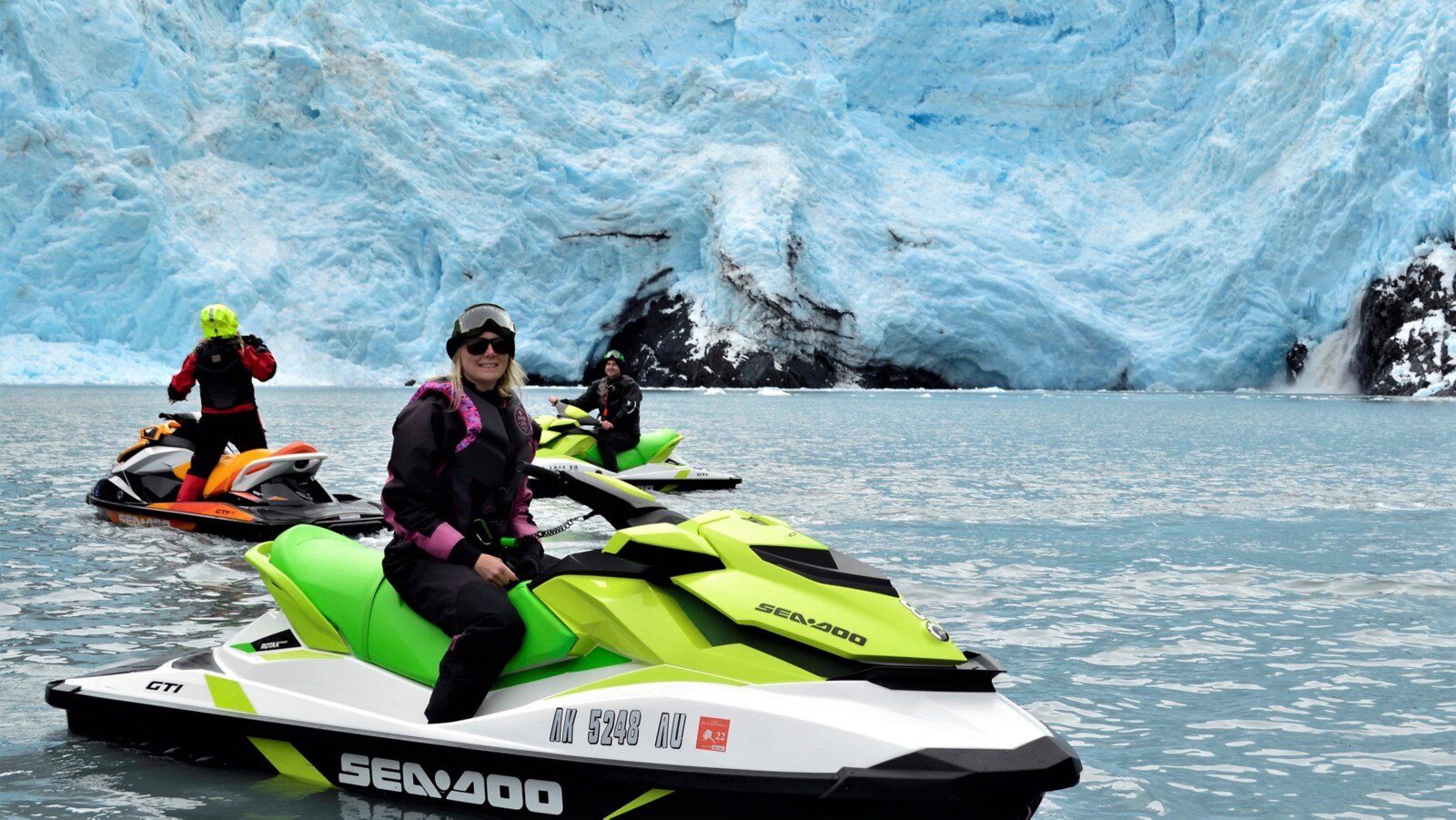 A group of people on personal watercraft in Alaska