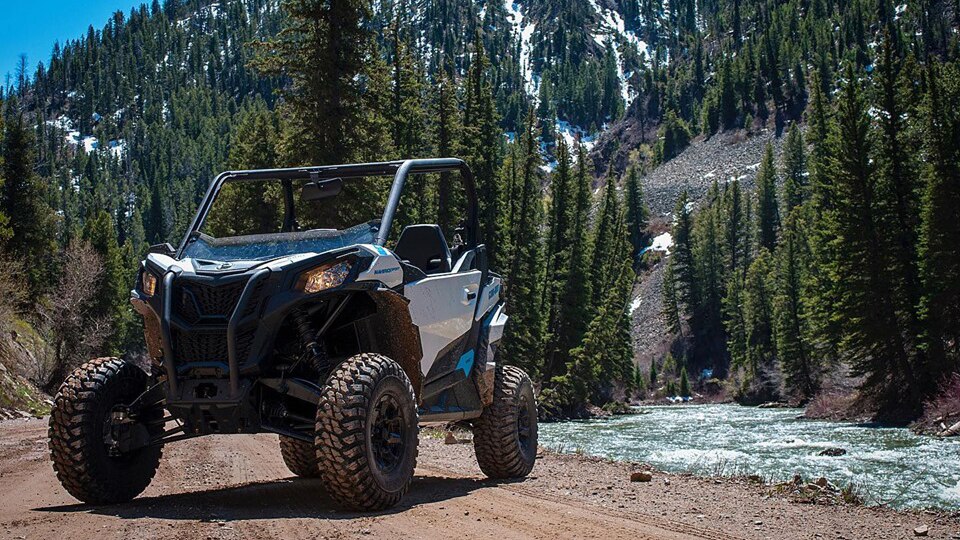 A Can-Am side-by-side parked in the mountains 