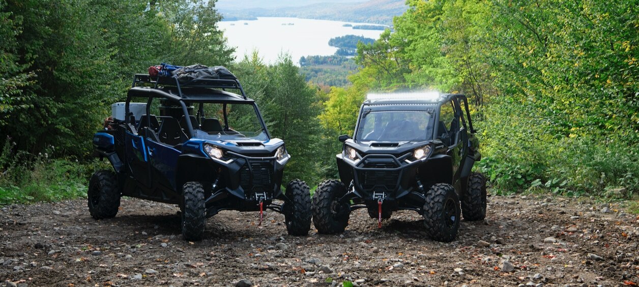 Two parked side-by-side vehicles in the mountains
