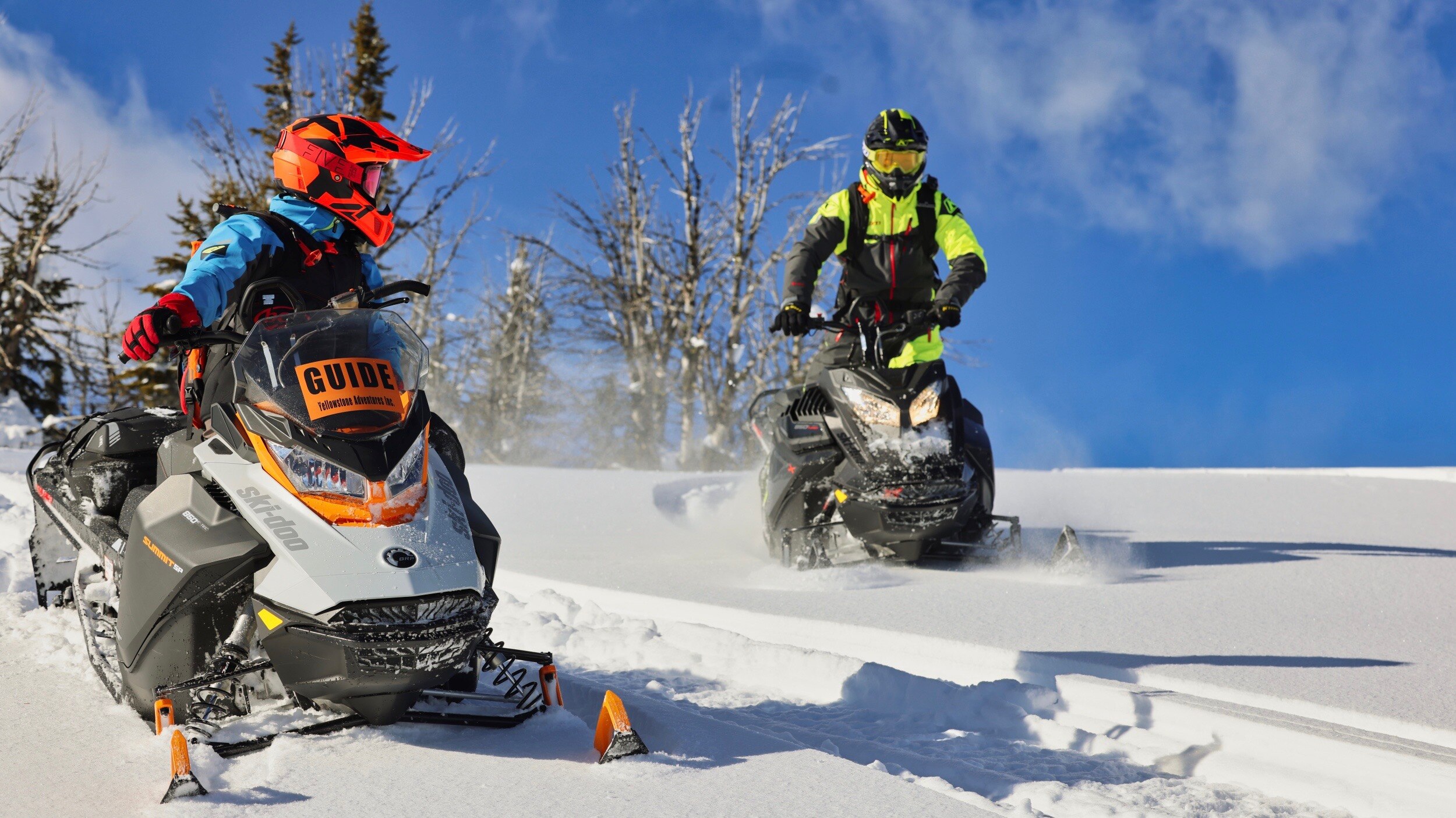 Two men riding a SkI-Doo in fresh snow