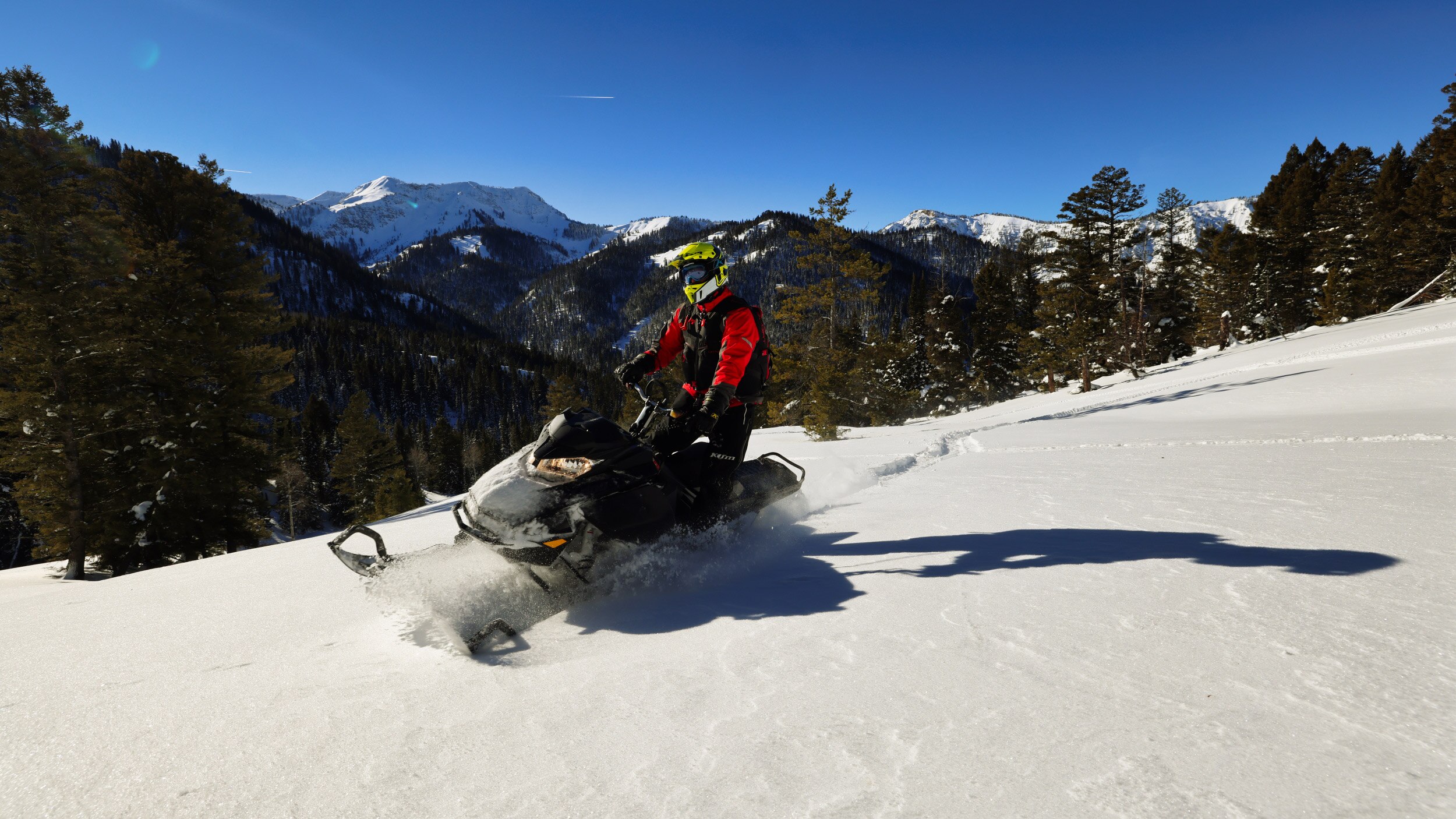 Snowmobiler riding in the mountains' open area