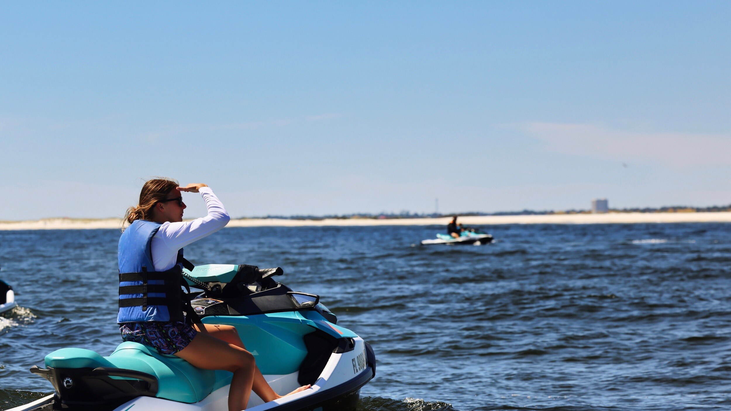 A woman looking for dolphins on a Sea-Doo