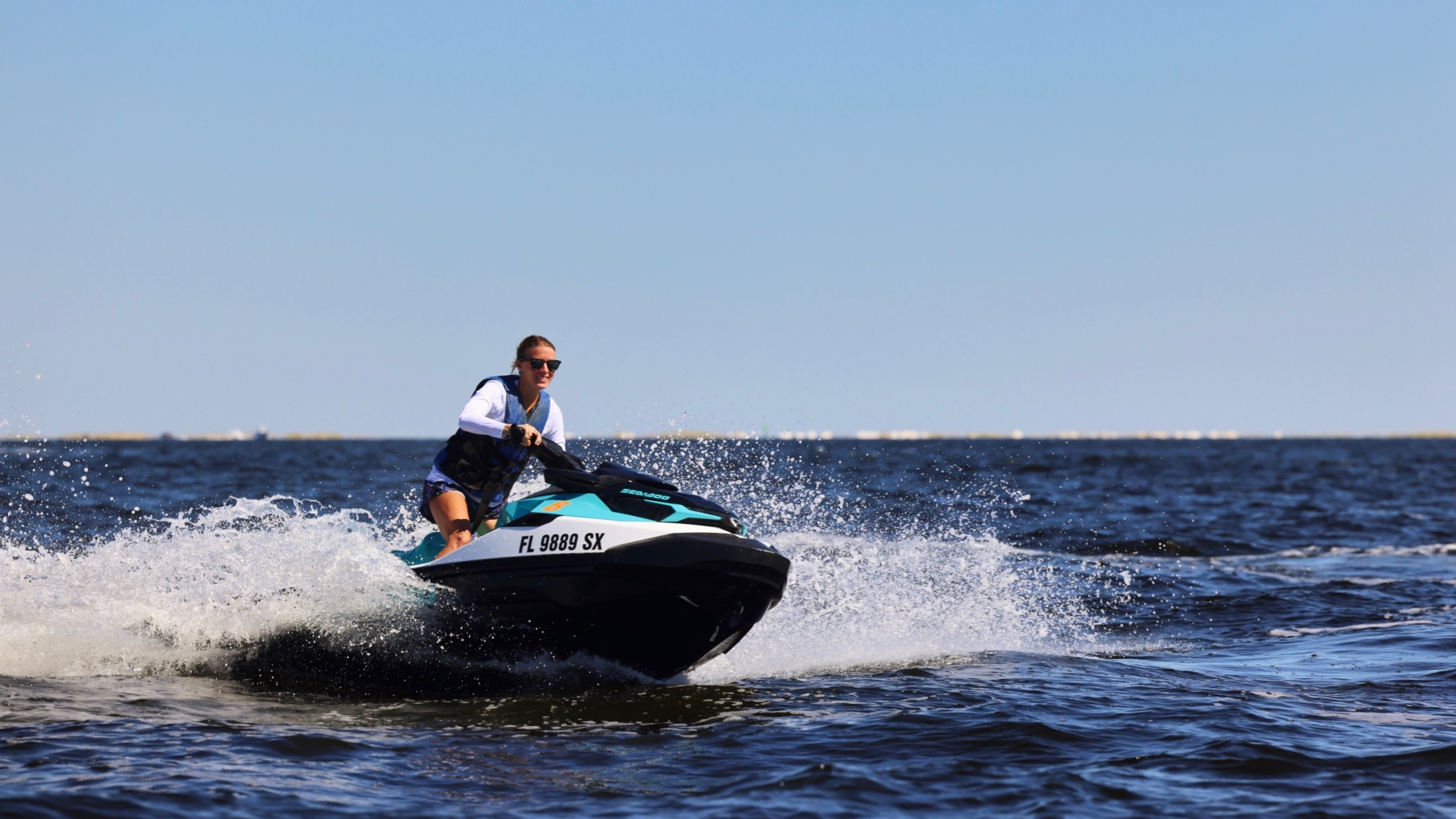 A woman riding a Sea-Doo in ocean