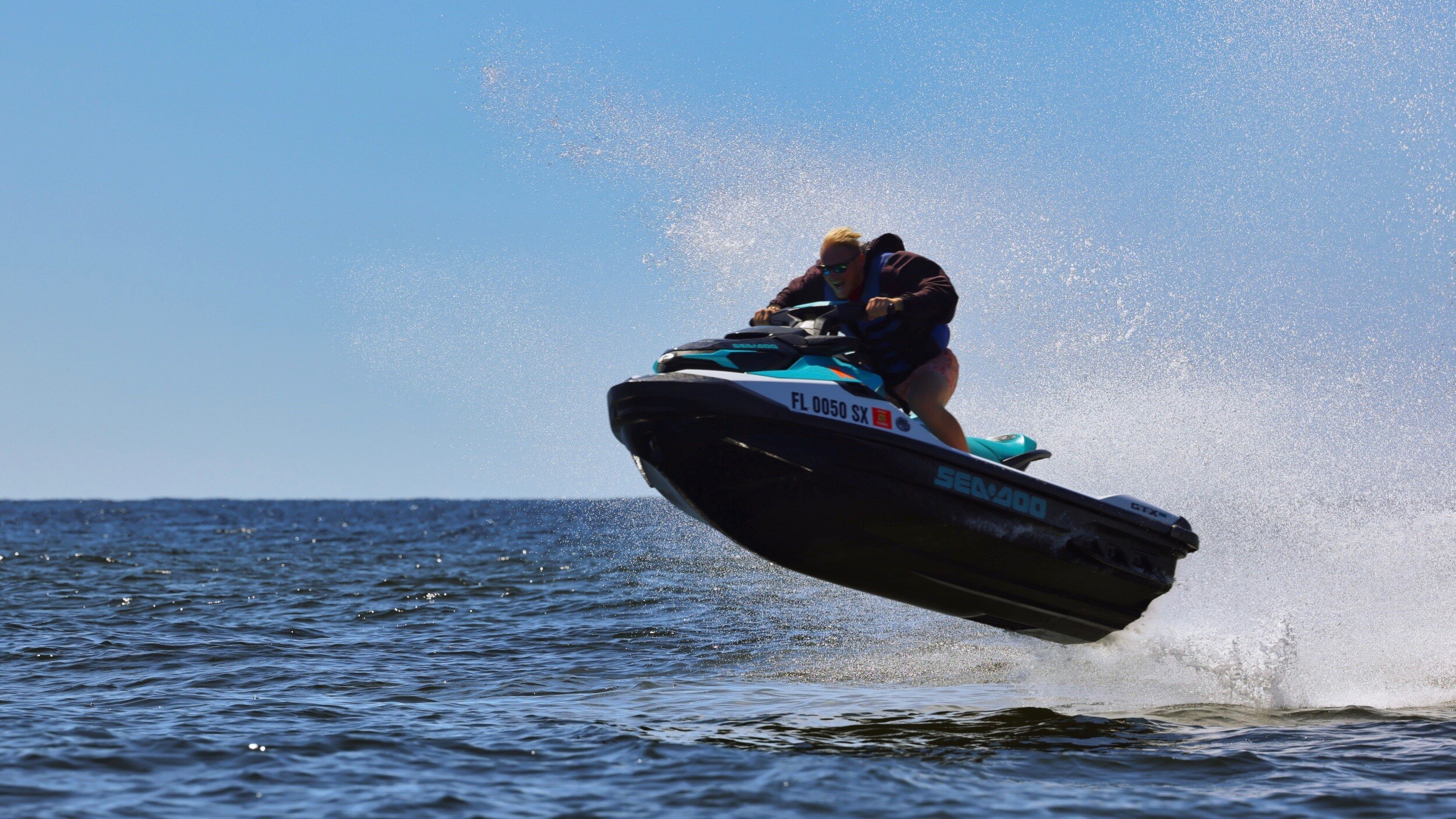 A man jumping in the air with a Sea-Doo