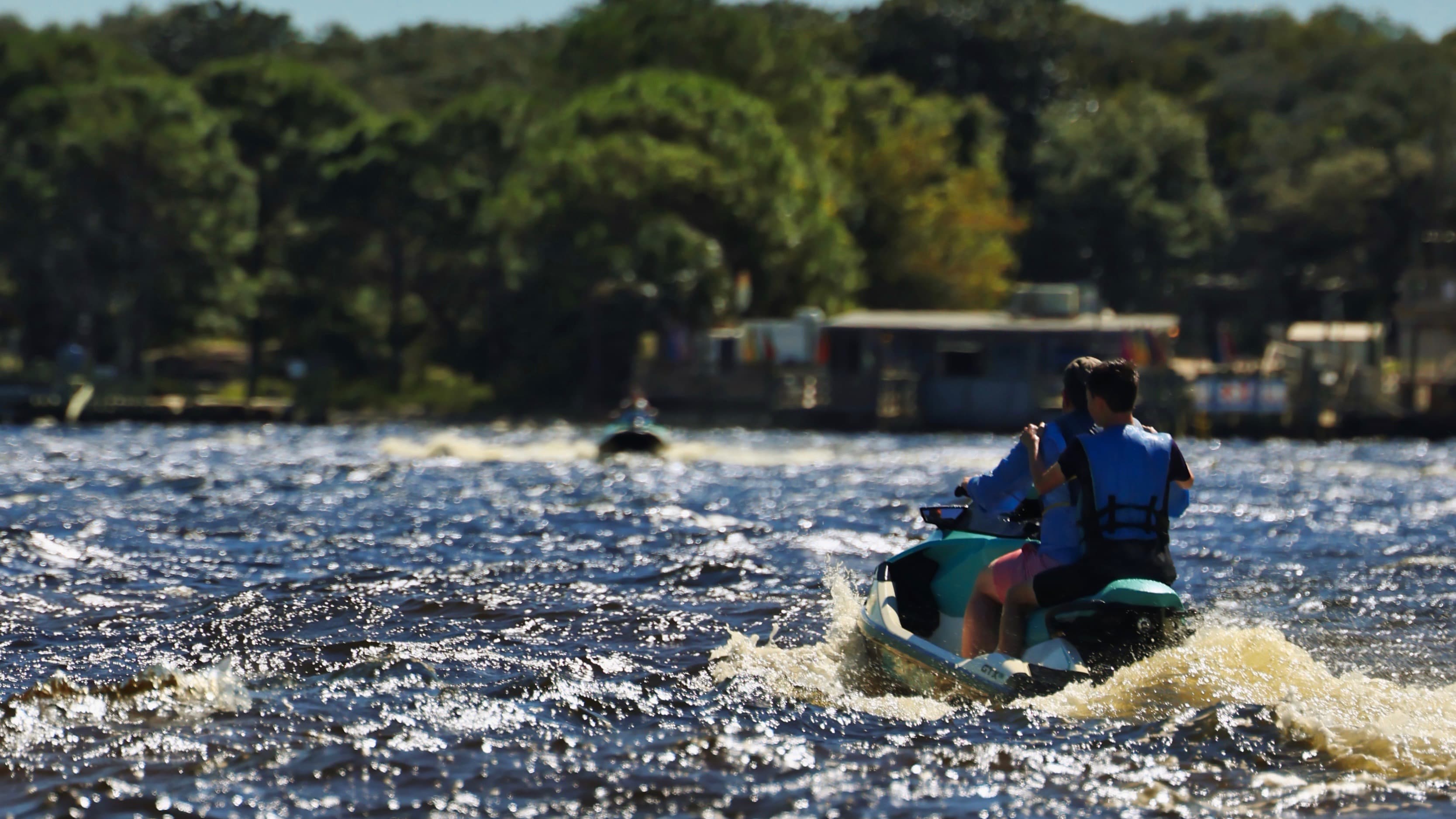 Two men on a PWC crusing the coast