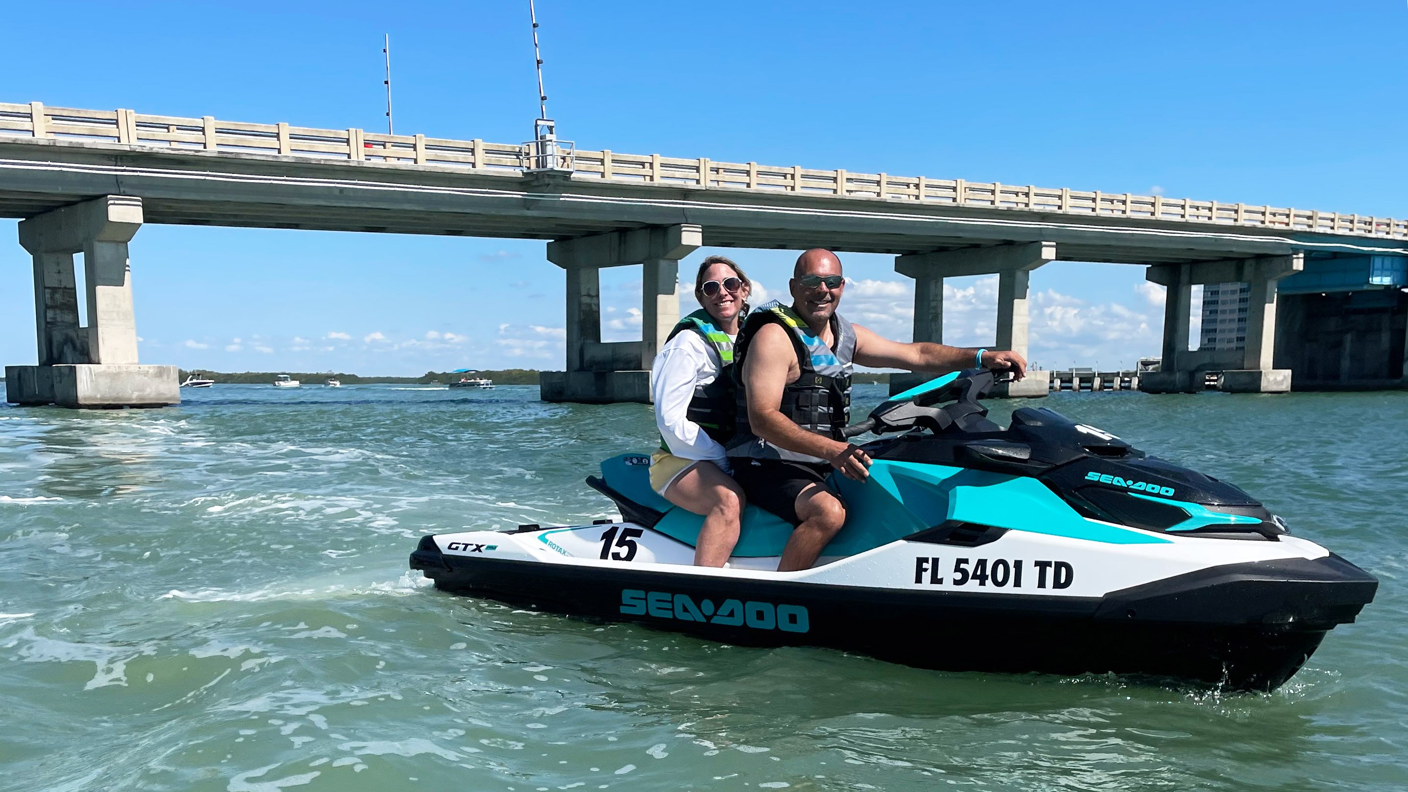 A couple on a Sea-Doo personal watercraft on the water