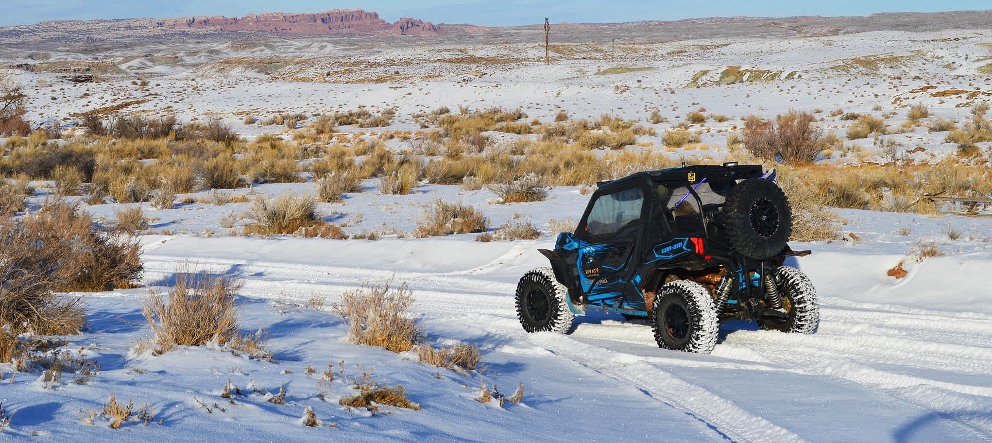 A Can-Am off-road parked with a canyon view
