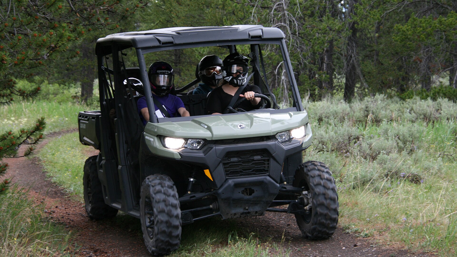 Riders inside the Can-Am Defender