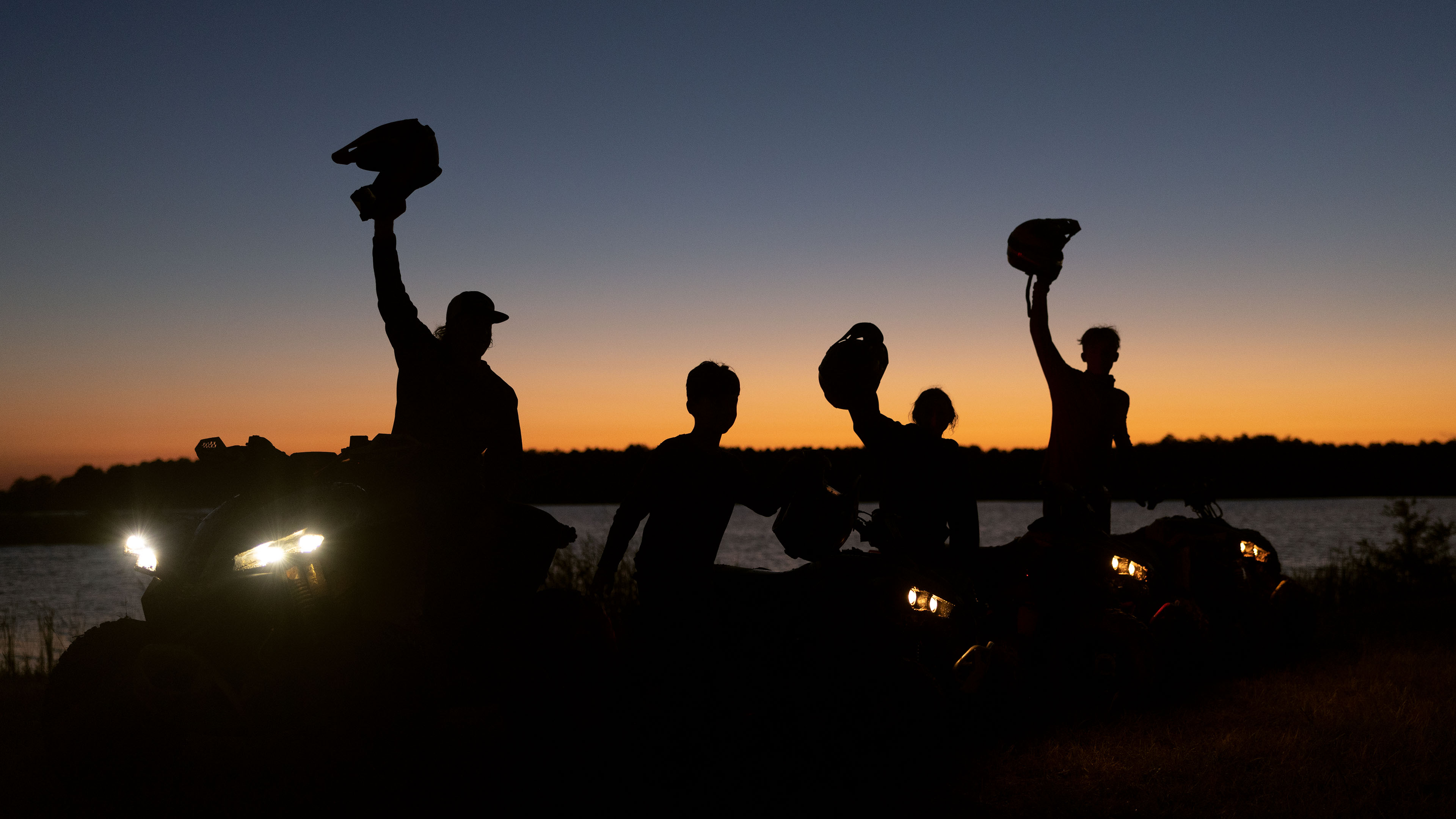 Riders cheering up on UTV watching the sunset