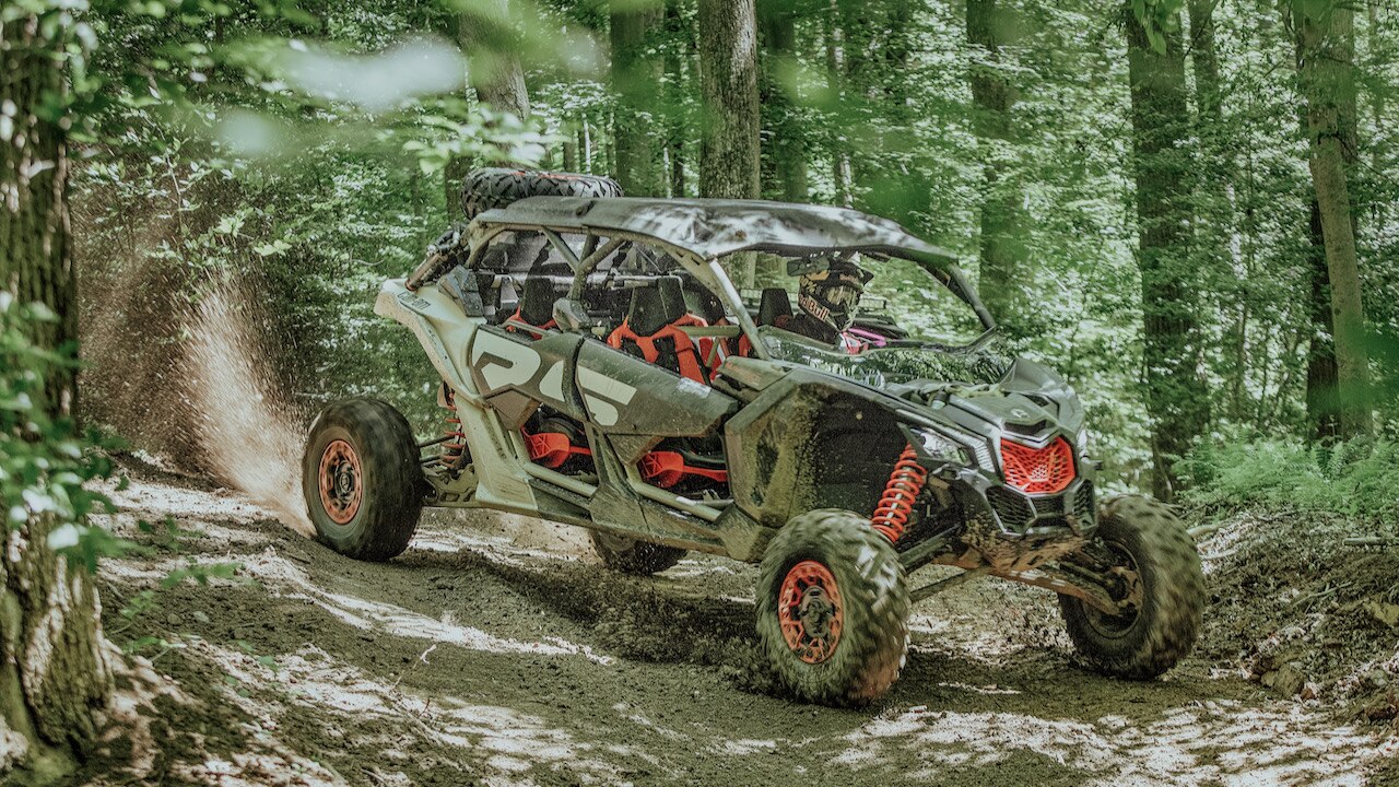 A Can-Am Off-Road vehicle in the forest trails