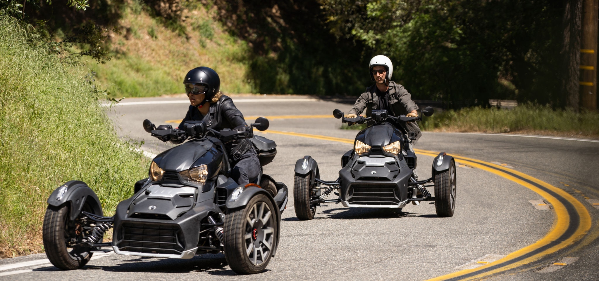 A couple each riding a Can-Am Ryker