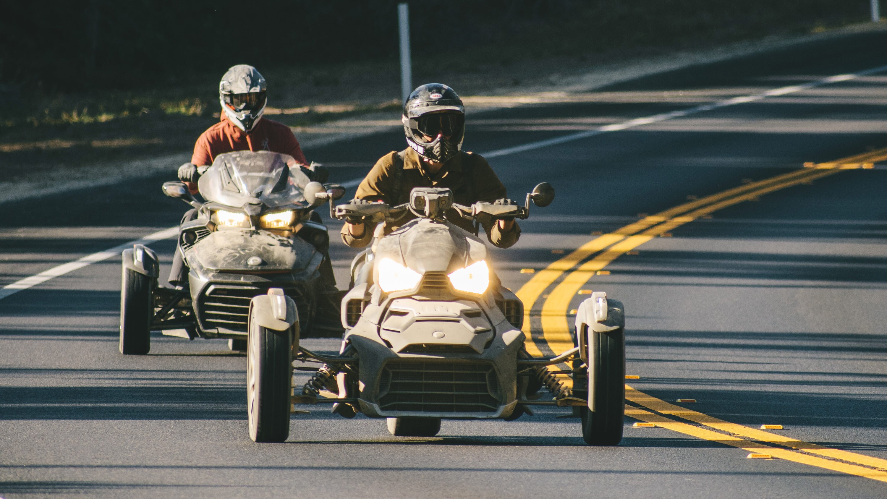 Two men admiring the desert view next to a parked Can-Am side-by-side