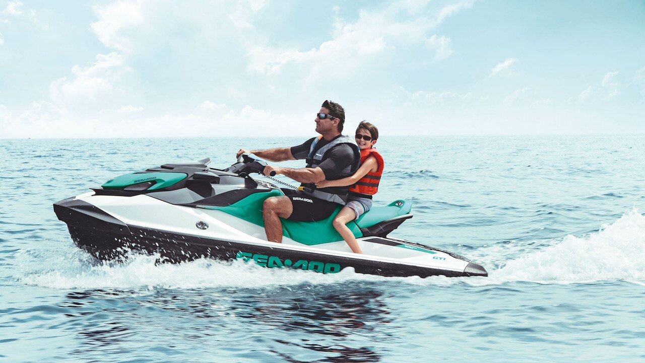 A father and his son on a Sea-Doo personal watercraft