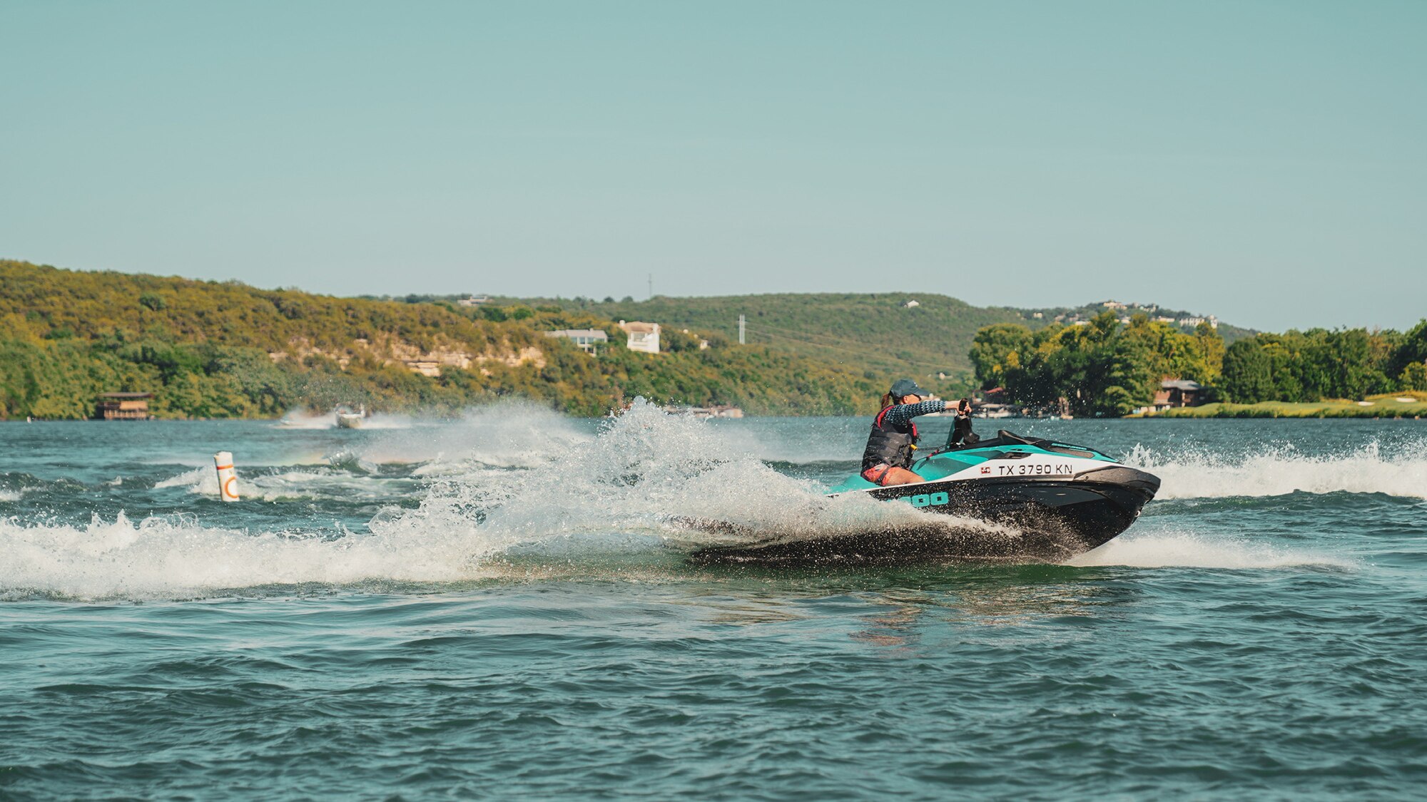 Woman turning with a personal watercraft on the water