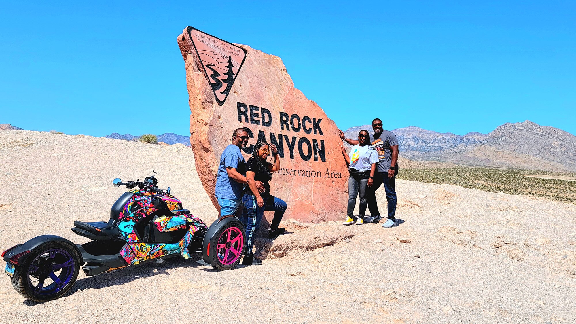 Two couples in front of the Red Rock Canyon sign