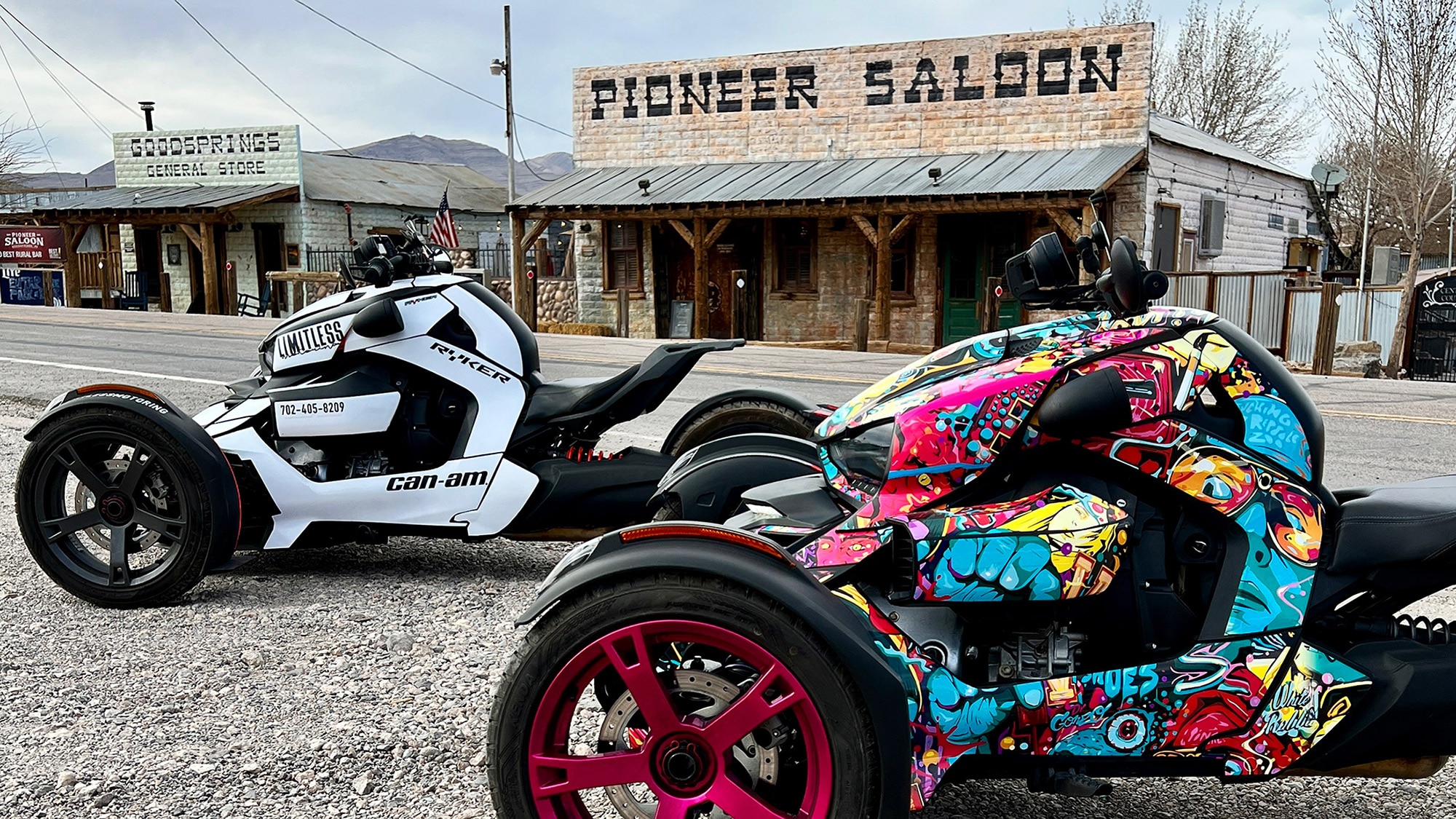 Two customized Rykers parked in front of an old saloon