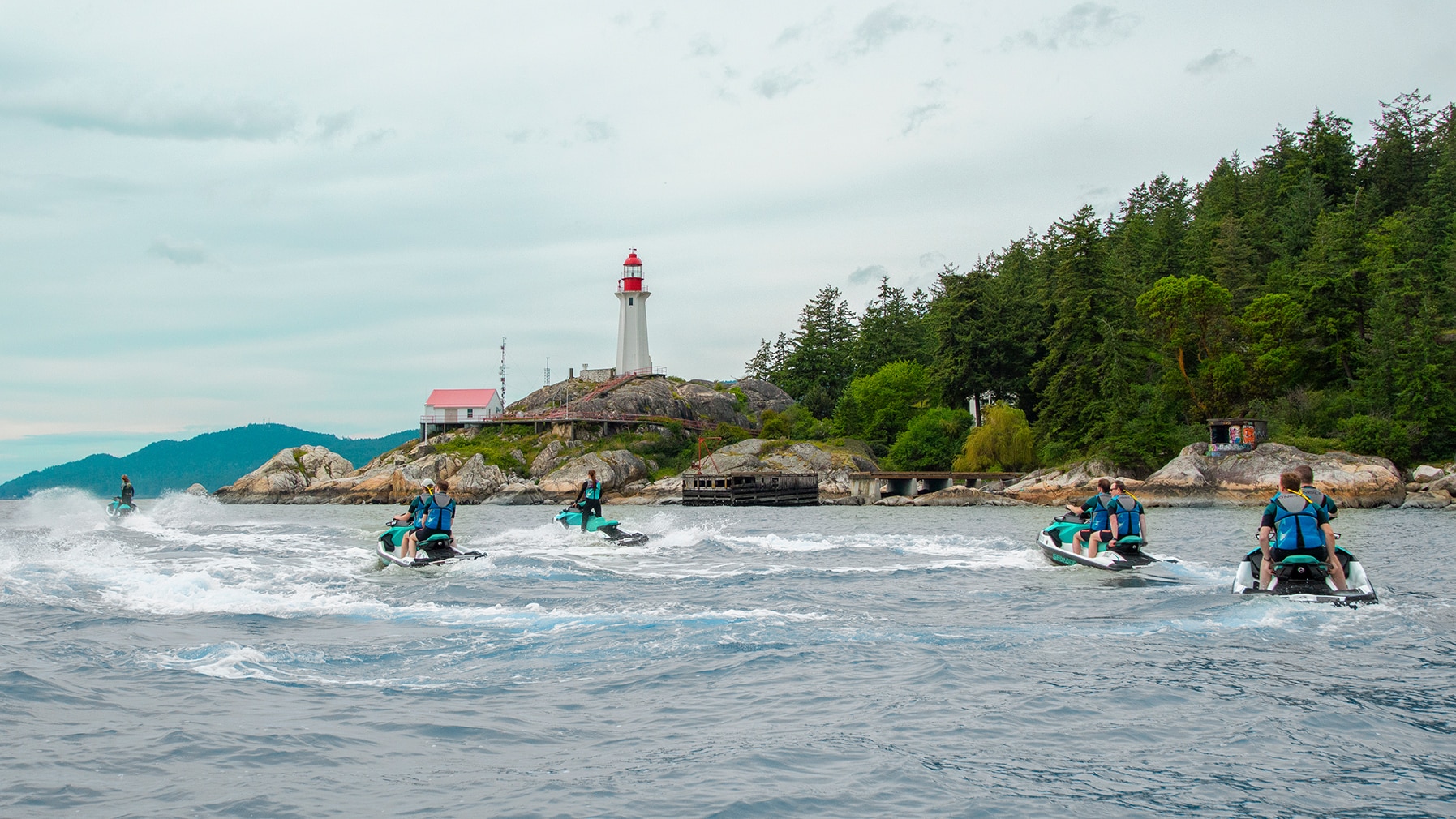 A group of people driving personal watercrafts